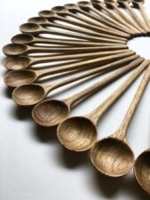 an array of carved wooden spoons